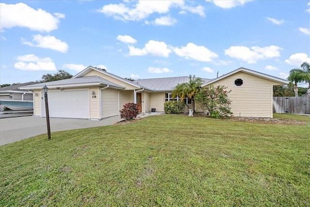 ranch-style house featuring a garage and a front lawn