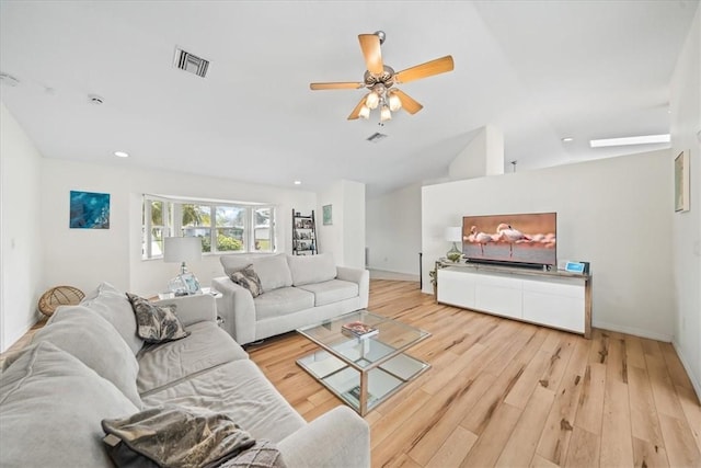 living room featuring light wood-type flooring, ceiling fan, and lofted ceiling