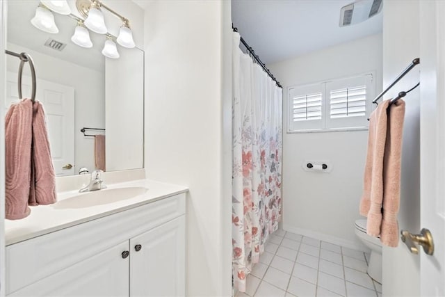 bathroom featuring toilet, tile patterned floors, and vanity