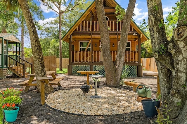 view of play area featuring a deck, fence, and stairs