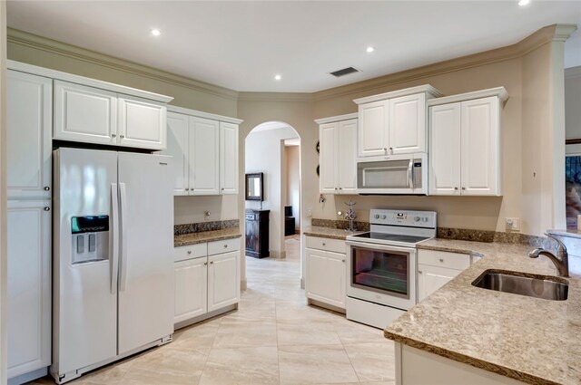 kitchen featuring sink, white cabinets, white appliances, light tile patterned floors, and ornamental molding