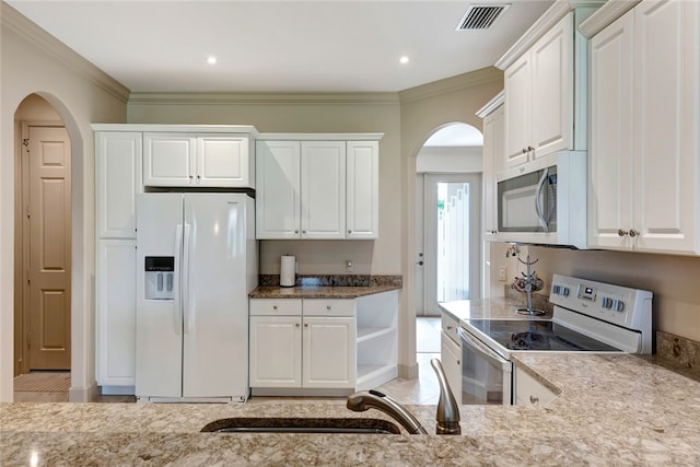 kitchen featuring white cabinets, white appliances, and ornamental molding