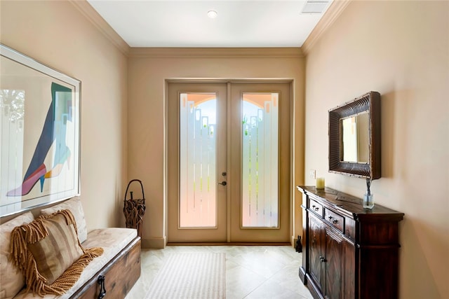 entryway with french doors, light tile patterned floors, and ornamental molding