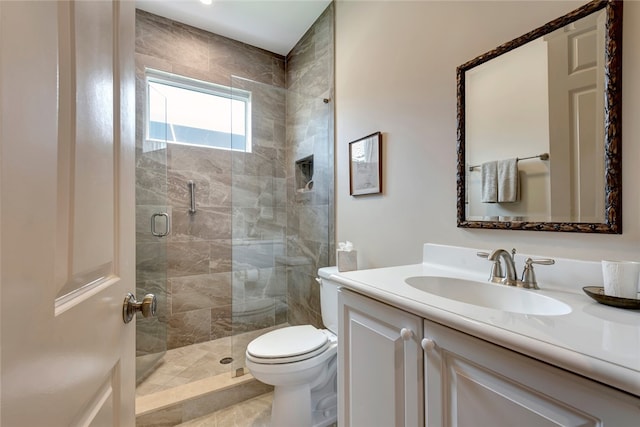 bathroom featuring tile patterned floors, vanity, toilet, and a shower with door