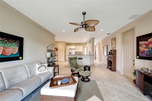 living room featuring ceiling fan and crown molding