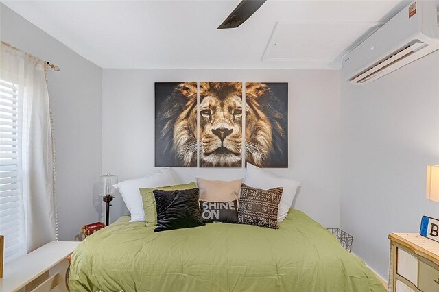 bedroom featuring ceiling fan and a wall mounted AC