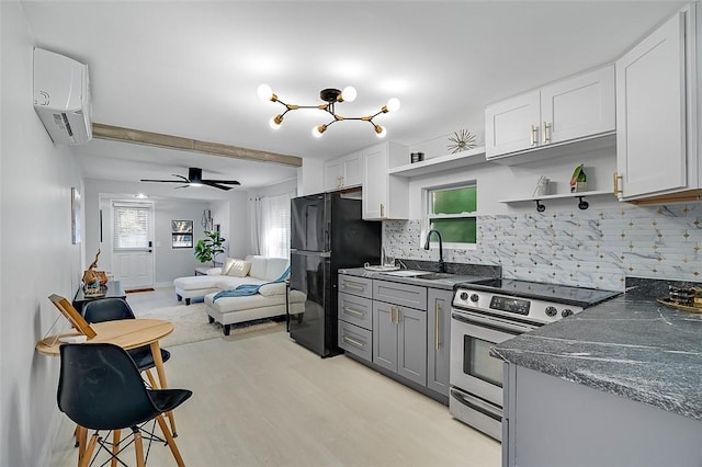 kitchen featuring an AC wall unit, white cabinetry, sink, backsplash, and electric stove