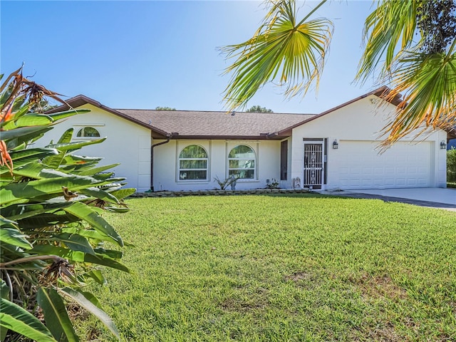 single story home featuring a garage and a front lawn