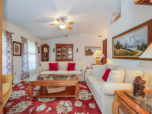 living room featuring ceiling fan and lofted ceiling