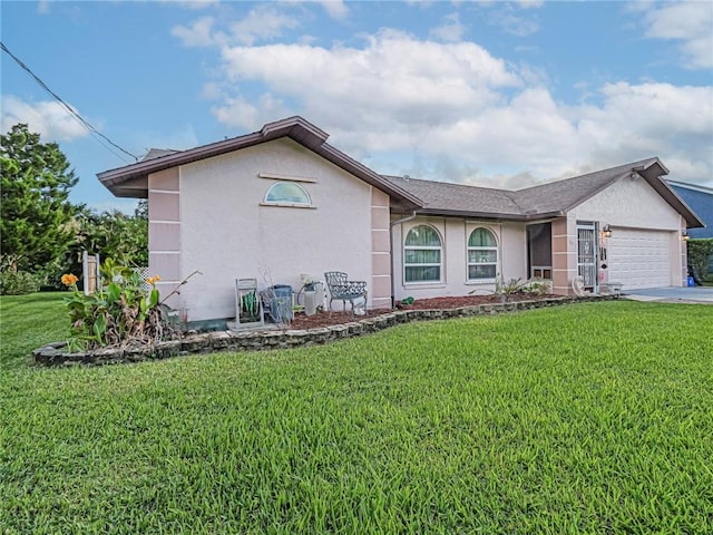 view of front of home with a front lawn and a garage