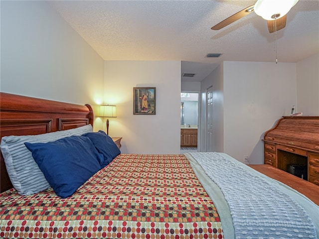 bedroom featuring ceiling fan, a textured ceiling, and ensuite bath