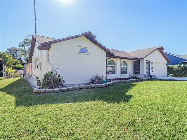 view of front of home with a garage and a front lawn