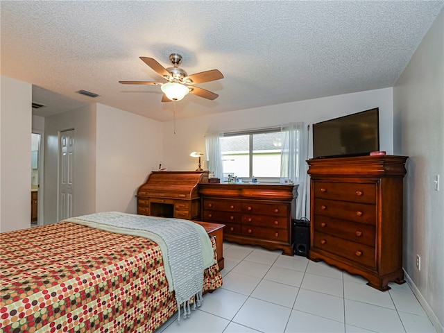 bedroom featuring light tile patterned floors, a textured ceiling, and ceiling fan