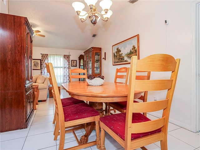 tiled dining room featuring ceiling fan with notable chandelier and vaulted ceiling