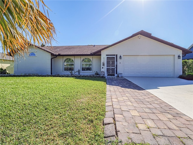 single story home featuring a front lawn and a garage