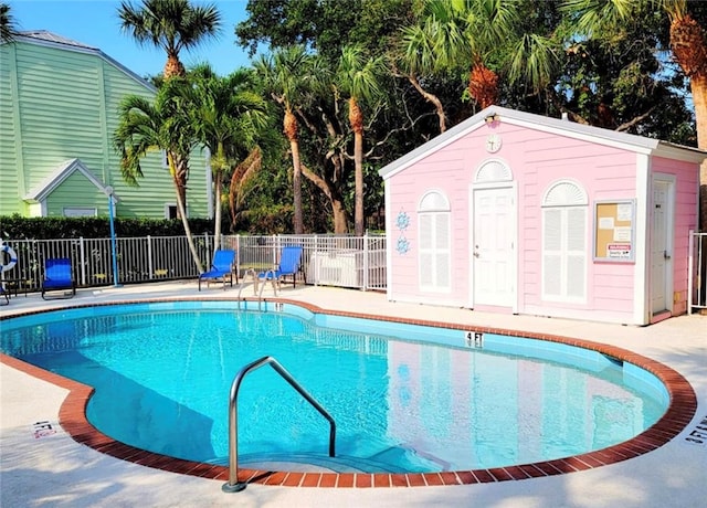 view of swimming pool featuring an outdoor structure