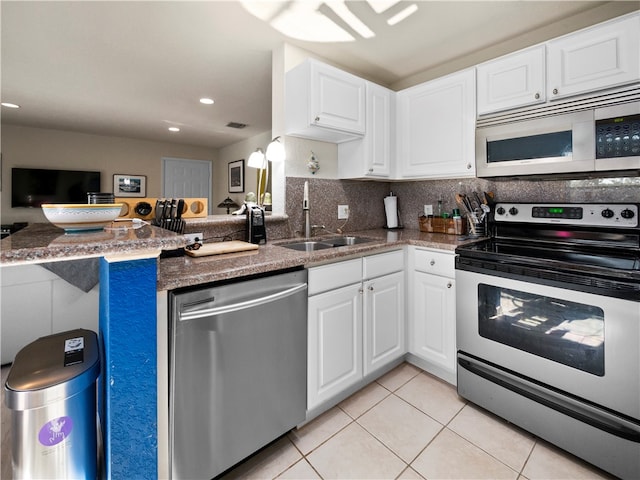 kitchen featuring kitchen peninsula, white cabinetry, sink, and appliances with stainless steel finishes