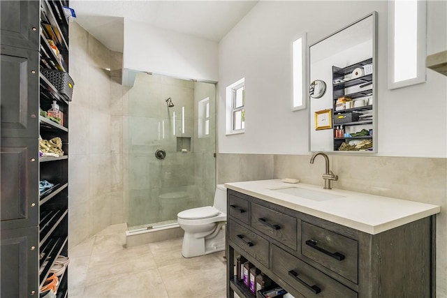 649 E Causeway Blvd, Vero Beach, FL 32963 - bathroom featuring vanity, a tile shower, tile walls, and tile patterned flooring