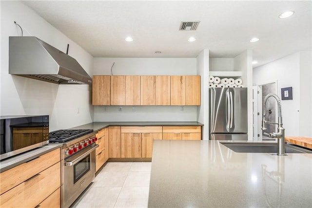 649 E Causeway Blvd, Vero Beach, FL 32963 - kitchen featuring stainless steel appliances, ventilation hood, light brown cabinetry, dark countertops, and recessed lighting