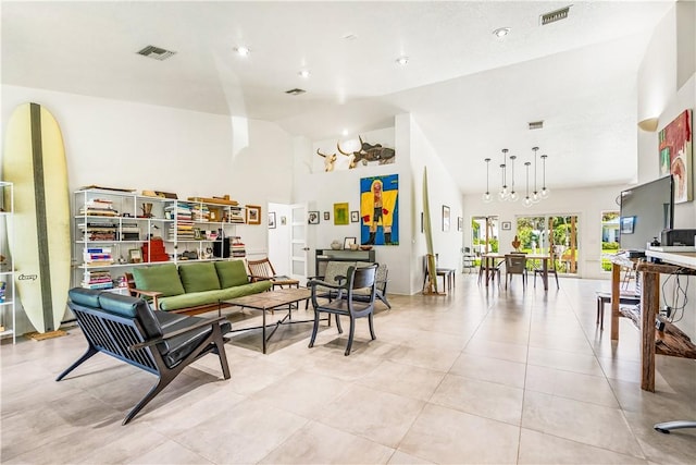 649 E Causeway Blvd, Vero Beach, FL 32963 - living room with high vaulted ceiling and light tile patterned floors