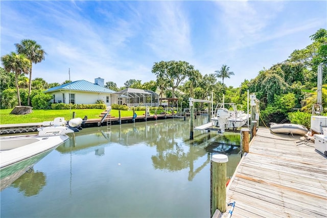 649 E Causeway Blvd, Vero Beach, FL 32963 - dock area with boat lift, a water view, and a yard