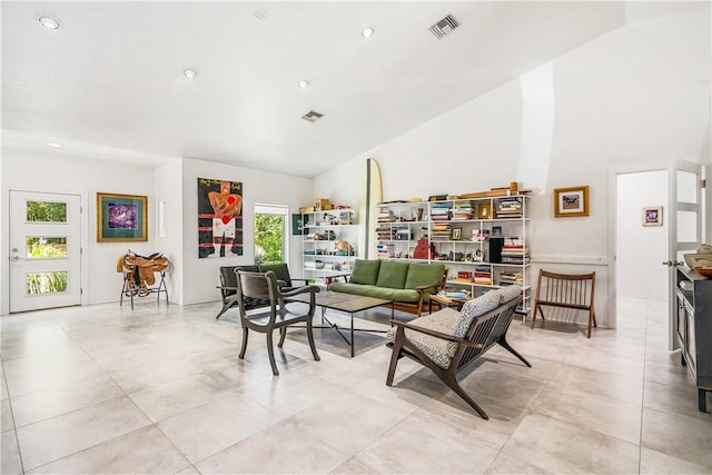 649 E Causeway Blvd, Vero Beach, FL 32963 - living area featuring high vaulted ceiling, recessed lighting, and light tile patterned flooring