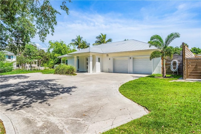 649 E Causeway Blvd, Vero Beach, FL 32963 - ranch-style house with stucco siding, an attached garage, and concrete driveway