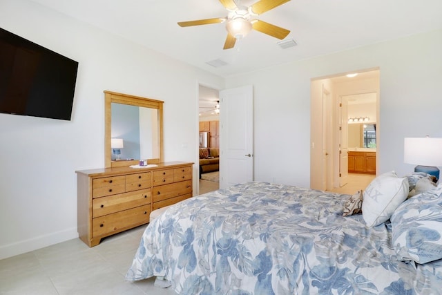 bedroom with visible vents, ensuite bathroom, light tile patterned flooring, baseboards, and ceiling fan