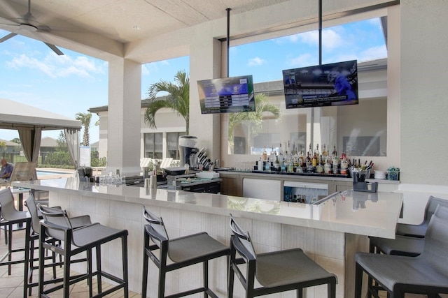 bar with a bar and ceiling fan