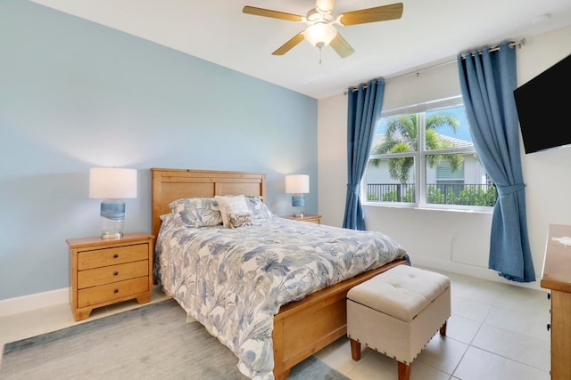 bedroom with light tile patterned floors, baseboards, and ceiling fan