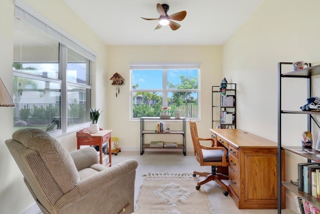 office featuring a ceiling fan and baseboards