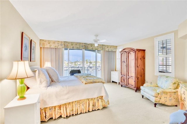 bedroom with ceiling fan, access to exterior, and carpet floors