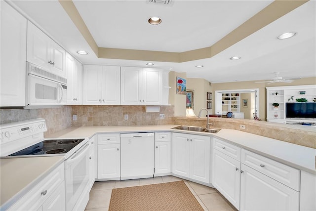 kitchen featuring sink, white cabinetry, white appliances, and light tile patterned flooring