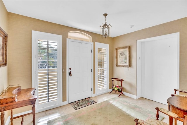 foyer entrance with light tile patterned flooring and a chandelier