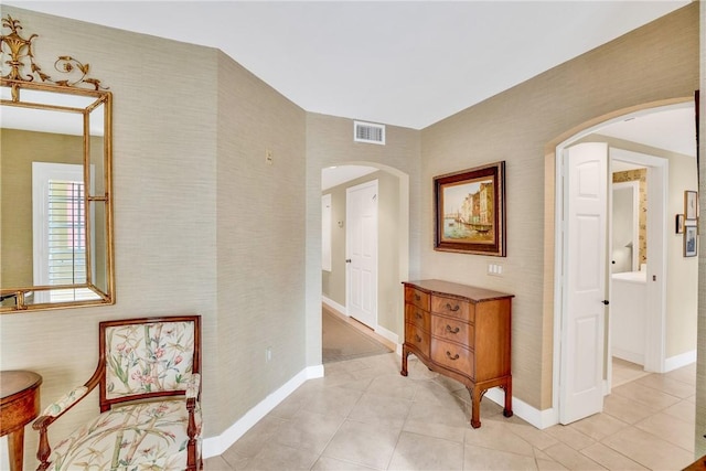 hall featuring light tile patterned floors