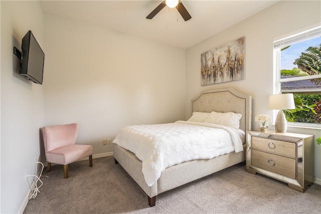 carpeted bedroom featuring multiple windows and ceiling fan