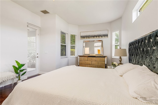 bedroom with dark hardwood / wood-style flooring