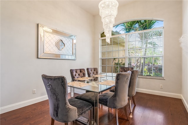 dining area with a notable chandelier and dark hardwood / wood-style floors