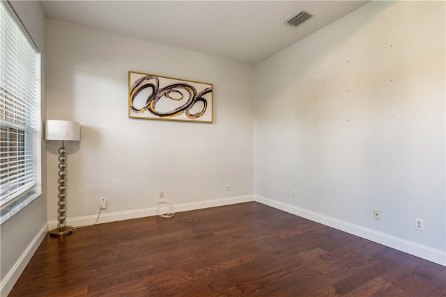 spare room with dark wood-type flooring