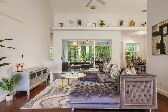 living room featuring dark hardwood / wood-style floors and ceiling fan