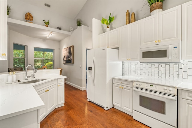 kitchen featuring sink, white cabinets, wood-type flooring, and white appliances