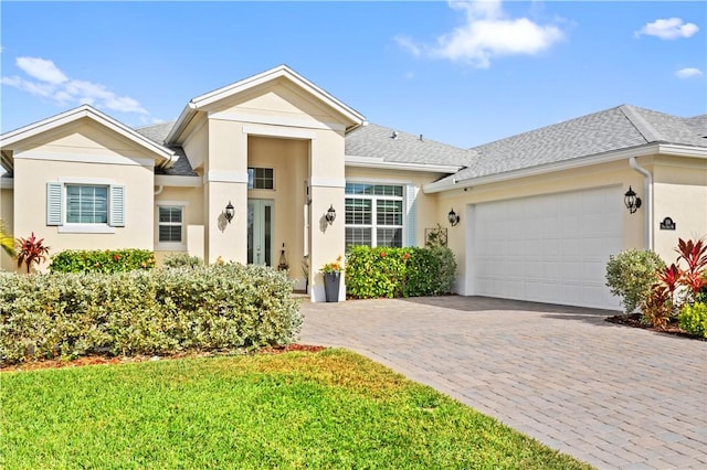 ranch-style house with a garage and a front yard