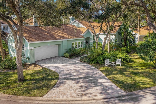 view of front of home with a garage and a front yard