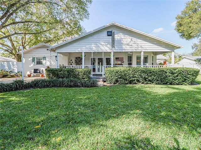 back of property featuring a yard and a porch