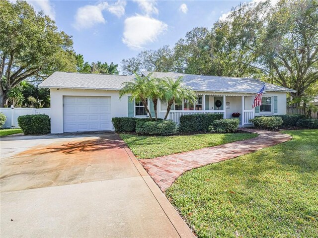 ranch-style house with a front yard and a garage