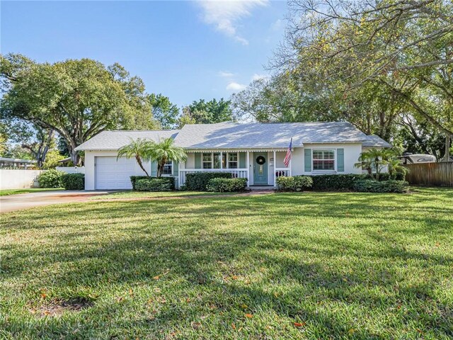 ranch-style home with a garage and a front yard