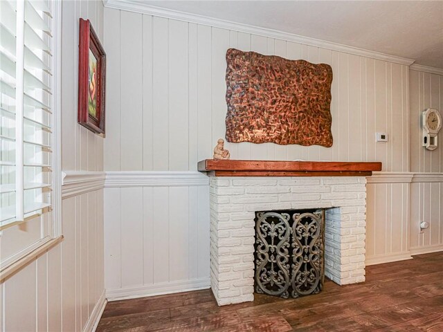 room details featuring a fireplace, hardwood / wood-style floors, and crown molding