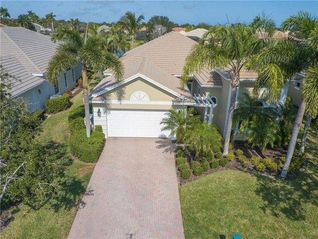 view of front of property featuring a garage and a front lawn