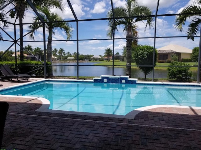 pool featuring a lanai, a water view, and a patio