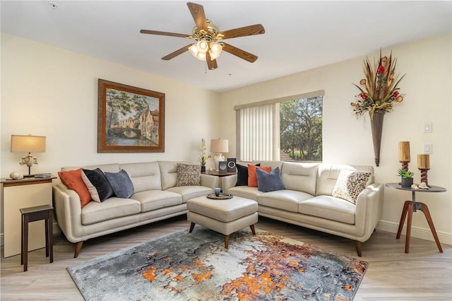 living area featuring ceiling fan, wood finished floors, and baseboards